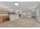 Open-concept living space featuring a fireplace, kitchen, and staircase with neutral tones at 5255 Memphis St # 1009, Denver, CO 80239