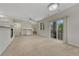 Spacious open-concept living room with a fireplace, large windows, and access to a balcony at 5255 Memphis St # 1009, Denver, CO 80239