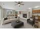 Comfortable living room with a fireplace, ceiling fan and open to kitchen area at 5255 Memphis St # 1009, Denver, CO 80239