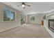 Spacious living area with natural light, fireplace, and sliding glass door to a balcony at 5255 Memphis St # 1009, Denver, CO 80239