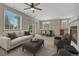 Comfortable living room with fireplace, ceiling fan and dining area at 5255 Memphis St # 1009, Denver, CO 80239