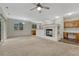 Bright and airy living room with a fireplace, connecting seamlessly to the kitchen and dining area at 5255 Memphis St # 1009, Denver, CO 80239
