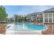 Beautiful community pool featuring a tanning deck and pergola-covered seating area at 5255 Memphis St # 1009, Denver, CO 80239