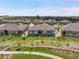 Expansive aerial view of a residential neighborhood with well-kept homes, green lawns, and a walking path at 25059 E Alder Dr, Aurora, CO 80016