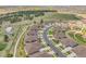 Extensive aerial view of a Primary-planned community featuring modern homes, green spaces, and a network of roads at 25059 E Alder Dr, Aurora, CO 80016