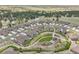 Overhead view of a residential neighborhood with curved streets, manicured lawns, and a central community park at 25059 E Alder Dr, Aurora, CO 80016