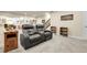 Finished basement with a reclining sofa, workspace, and staircase at 25059 E Alder Dr, Aurora, CO 80016