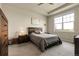 Tranquil bedroom with tray ceilings, a queen-sized bed, and abundant natural light from the expansive windows at 25059 E Alder Dr, Aurora, CO 80016