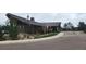 Clubhouse with stone accents, a covered entryway, and surrounding landscape at 25059 E Alder Dr, Aurora, CO 80016