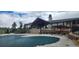 Community pool covered and ready for the off season with a clubhouse in the background at 25059 E Alder Dr, Aurora, CO 80016