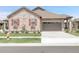 Exterior shot of a single-Gathering home with a stone facade, red shutters, and an attached two-car garage at 25059 E Alder Dr, Aurora, CO 80016