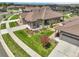 View of a single-story home with mature landscaping and neutral stone and brown siding at 25059 E Alder Dr, Aurora, CO 80016
