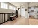 Welcoming home foyer with hardwood floors and a view of the modern white kitchen at 25059 E Alder Dr, Aurora, CO 80016