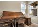 Close up of a classic rolltop desk and comfortable office chair next to a bright window, perfect work space at 25059 E Alder Dr, Aurora, CO 80016