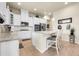 Modern kitchen with white cabinets, stainless steel appliances, and a center island with bar seating at 25059 E Alder Dr, Aurora, CO 80016