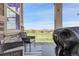 Outdoor patio with seating area, grill, and picturesque views of the green space and surrounding neighborhood at 25059 E Alder Dr, Aurora, CO 80016