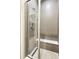Modern shower with sleek grey tiling, glass enclosure, rainfall shower head, and built-in bench for a spa-like experience at 25059 E Alder Dr, Aurora, CO 80016