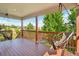 Spacious back deck features two hanging lounge chairs and a wood railing at 4920 S Netherland Way, Centennial, CO 80015
