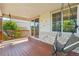 Covered wooden back deck with two hanging lounge chairs and stone accents at 4920 S Netherland Way, Centennial, CO 80015