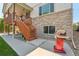 Backyard view featuring stone detail, wooden staircase and a red grill at 4920 S Netherland Way, Centennial, CO 80015