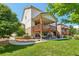Beautifully landscaped backyard featuring a spacious deck, a hammock, and lush green grass at 4920 S Netherland Way, Centennial, CO 80015