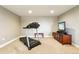 Basement workout area with a treadmill and entertainment area at 4920 S Netherland Way, Centennial, CO 80015