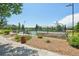 Outdoor basketball court surrounded by trees and landscaping with nearby benches at 4920 S Netherland Way, Centennial, CO 80015