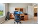 This bedroom includes a wooden desk and built-in shelving perfect for a study space at 4920 S Netherland Way, Centennial, CO 80015