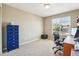 Bright, carpeted bedroom, with blue decorative cabinet and natural light from the window at 4920 S Netherland Way, Centennial, CO 80015