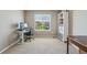 Carpeted bedroom with desk area, natural lighting, and storage shelves, ideal for work or study at 4920 S Netherland Way, Centennial, CO 80015
