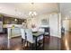 Open-concept dining area with hardwood floors and stylish lighting adjacent to the kitchen at 4920 S Netherland Way, Centennial, CO 80015