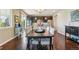 Dining area with a view of the kitchen, stainless steel appliances, and a modern table setting at 4920 S Netherland Way, Centennial, CO 80015