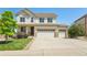Inviting two-story home featuring a three car garage, manicured lawn, and charming front porch at 4920 S Netherland Way, Centennial, CO 80015