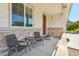 Relaxing front porch with chairs, table, and stone accents creating an inviting outdoor space at 4920 S Netherland Way, Centennial, CO 80015