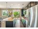 Bright kitchen with granite island, stainless appliances and a sliding door to the outdoor deck at 4920 S Netherland Way, Centennial, CO 80015