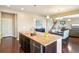 Open kitchen with a large island and stainless steel appliances connects seamlessly to the dining area at 4920 S Netherland Way, Centennial, CO 80015