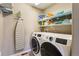 Efficient laundry room featuring a modern washer and dryer and practical storage shelving at 4920 S Netherland Way, Centennial, CO 80015