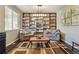 Inviting living room features custom shelving, wood floors and a cozy seating area at 4920 S Netherland Way, Centennial, CO 80015