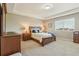 This main bedroom boasts neutral paint, a tray ceiling, and carpet flooring for added comfort at 4920 S Netherland Way, Centennial, CO 80015