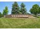 Stone community sign with mature trees set in a manicured lawn at 4920 S Netherland Way, Centennial, CO 80015