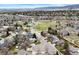Scenic aerial view of a residential neighborhood with tree-lined streets, a pond, and distant mountain views at 10629 W Glasgow Ave, Littleton, CO 80127