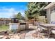 Outdoor kitchen area with built-in grill, countertop, stone accents, table and chairs at 10629 W Glasgow Ave, Littleton, CO 80127