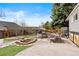 Backyard with outdoor kitchen, fire pit, seating area, and lush landscaping at 10629 W Glasgow Ave, Littleton, CO 80127