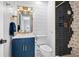 Modern bathroom featuring a vanity, shower, and toilet with stylish fixtures at 10629 W Glasgow Ave, Littleton, CO 80127