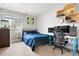 Cozy bedroom featuring a comfortable bed, carpet, and functional workspace at 10629 W Glasgow Ave, Littleton, CO 80127