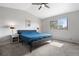 A bright bedroom featuring a comfortable bed, carpeted floor, and a window at 10629 W Glasgow Ave, Littleton, CO 80127