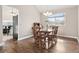 Formal dining room featuring hardwood floors, a window view, and wood table with seating for six at 10629 W Glasgow Ave, Littleton, CO 80127