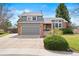 Charming two-story home with brick accents, attached garage, and a well-manicured front yard at 10629 W Glasgow Ave, Littleton, CO 80127