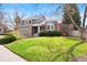 Inviting front lawn of a two-story house with brick accents and mature trees at 10629 W Glasgow Ave, Littleton, CO 80127