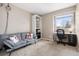 Inviting home office with a comfortable sofa, desk, chair, and ample storage at 10629 W Glasgow Ave, Littleton, CO 80127
